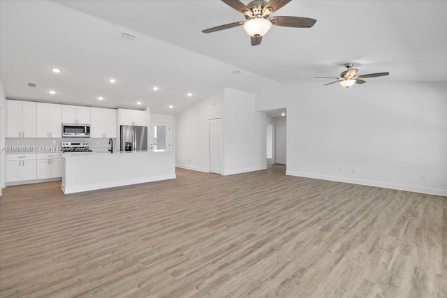 520 SW 28th St, Cape Coral, FL 33914 - unfurnished living room featuring vaulted ceiling, a ceiling fan, recessed lighting, and light wood finished floors