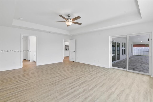 520 SW 28th St, Cape Coral, FL 33914 - unfurnished room with a tray ceiling, a ceiling fan, and light wood finished floors