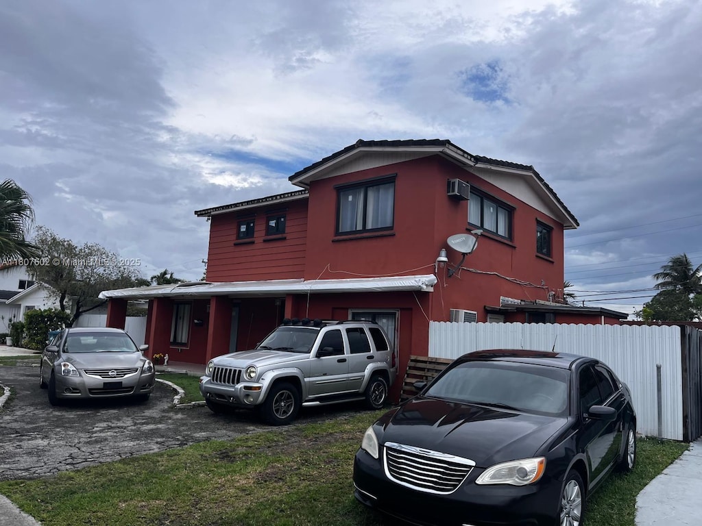 1735 SW 97th Pl, Miami, FL 33165 - view of front of home with a wall mounted air conditioner and asphalt driveway