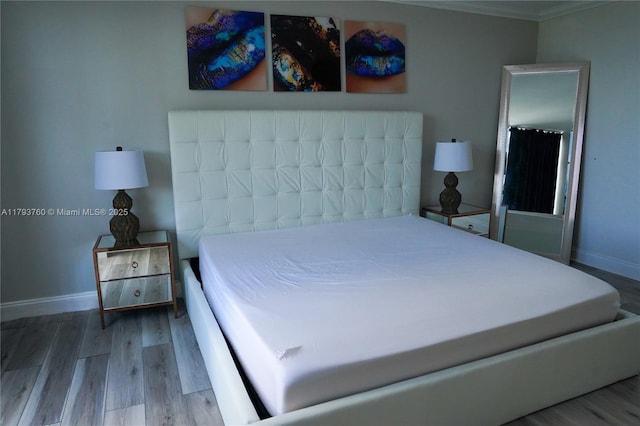 500 Three Islands Blvd Unit 106, Hallandale Beach, FL 33009 - bedroom featuring wood finished floors, baseboards, and ornamental molding