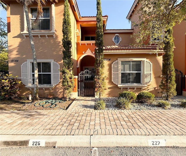 12154 SW 27th St Unit 1102, Miramar, FL 33025 - view of front of property with stucco siding and a gate