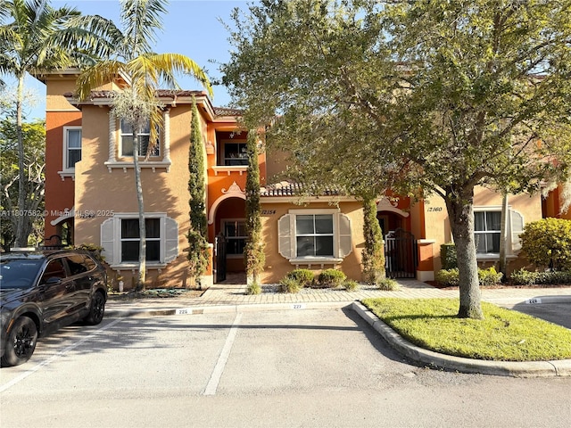12154 SW 27th St Unit 1102, Miramar, FL 33025 - view of front facade with stucco siding and uncovered parking
