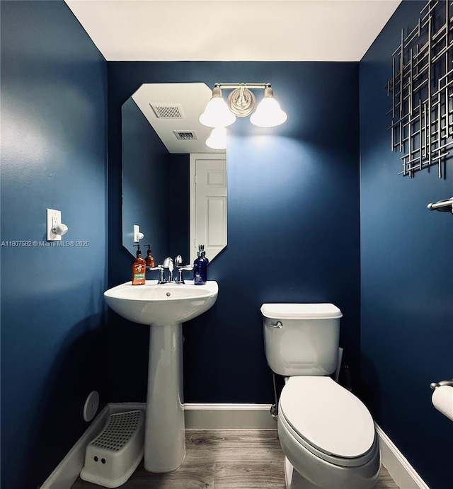 12154 SW 27th St Unit 1102, Miramar, FL 33025 - half bath featuring wood finished floors, toilet, and baseboards