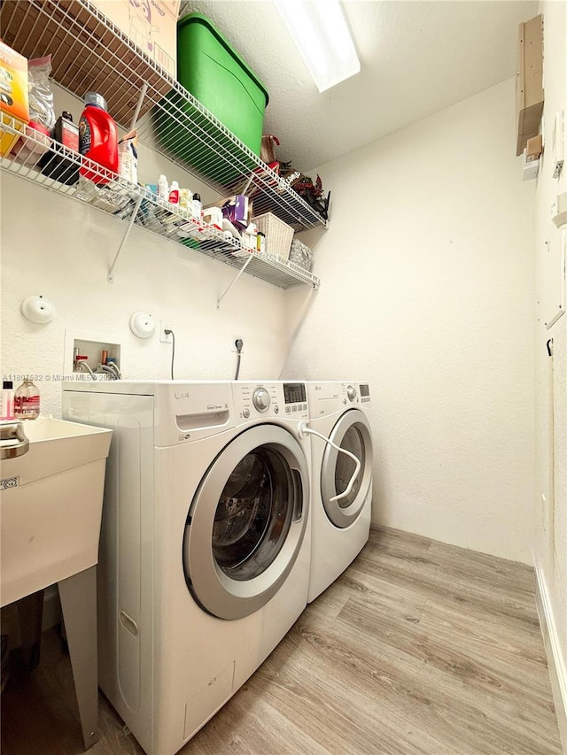 12154 SW 27th St Unit 1102, Miramar, FL 33025 - washroom featuring light wood-type flooring and washer and dryer