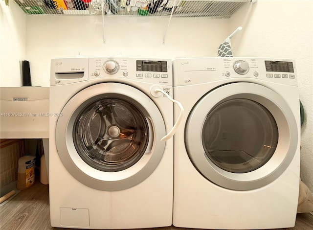 12154 SW 27th St Unit 1102, Miramar, FL 33025 - washroom featuring washing machine and clothes dryer and wood finished floors