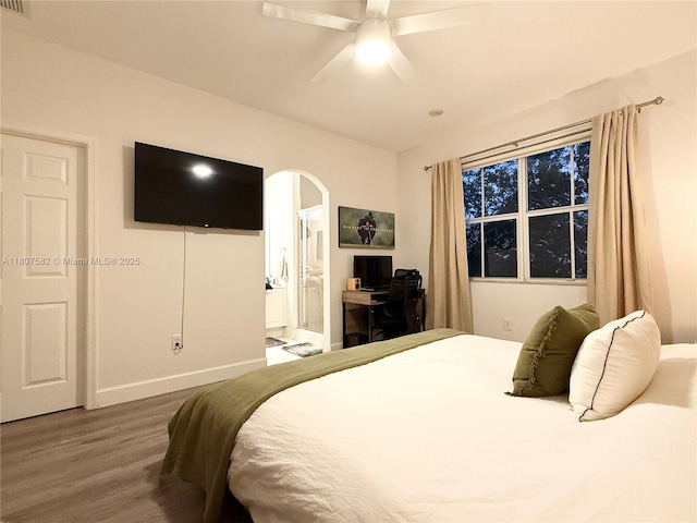 12154 SW 27th St Unit 1102, Miramar, FL 33025 - bedroom featuring wood finished floors, arched walkways, baseboards, ensuite bath, and a ceiling fan