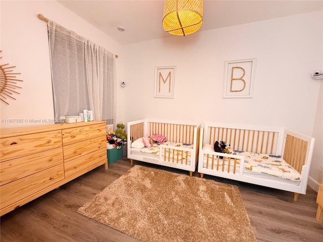 12154 SW 27th St Unit 1102, Miramar, FL 33025 - bedroom featuring wood finished floors and a crib