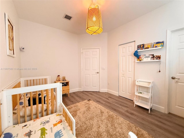 12154 SW 27th St Unit 1102, Miramar, FL 33025 - bedroom featuring wood finished floors, a nursery area, and baseboards