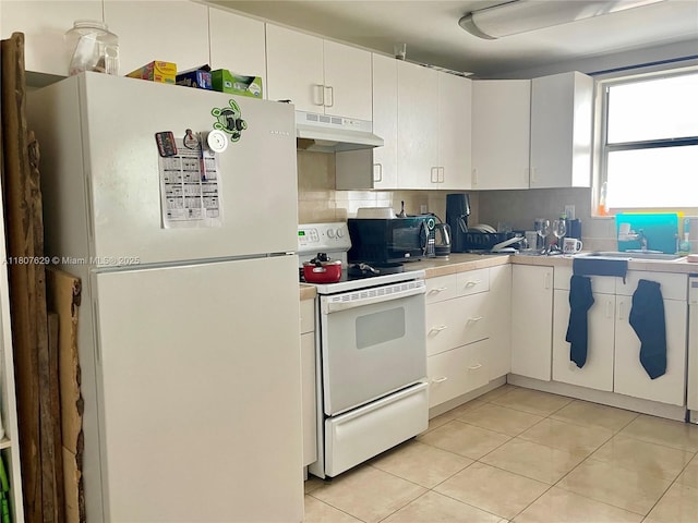 2750 NE 183rd St Unit 2308, Aventura, FL 33160 - kitchen with white appliances, under cabinet range hood, light countertops, white cabinets, and decorative backsplash