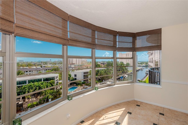 3051 NE 48th St Unit 604, Fort Lauderdale, FL 33308 - unfurnished sunroom with plenty of natural light, a water view, and tile patterned floors