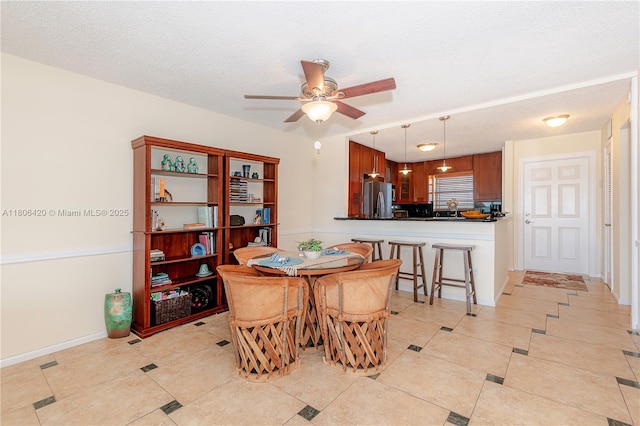 3051 NE 48th St Unit 604, Fort Lauderdale, FL 33308 - dining area with ceiling fan, a textured ceiling, light tile patterned flooring, and baseboards