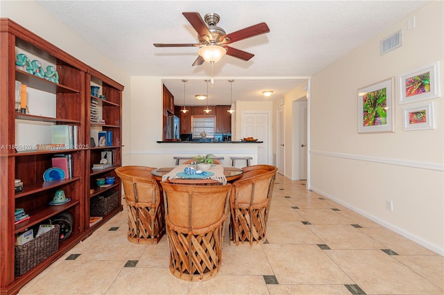 3051 NE 48th St Unit 604, Fort Lauderdale, FL 33308 - dining area with a ceiling fan, a textured ceiling, light tile patterned floors, and baseboards