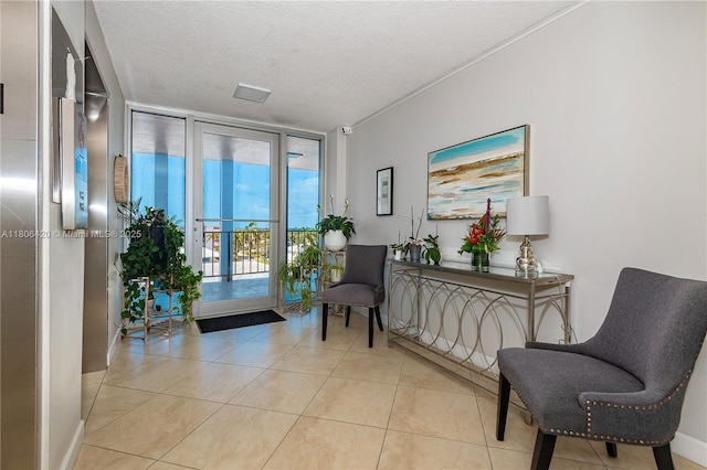 3051 NE 48th St Unit 604, Fort Lauderdale, FL 33308 - sitting room with a wall of windows, light tile patterned floors, and a textured ceiling