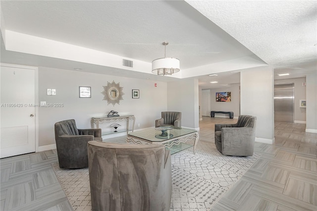 3051 NE 48th St Unit 604, Fort Lauderdale, FL 33308 - living room featuring a textured ceiling and baseboards