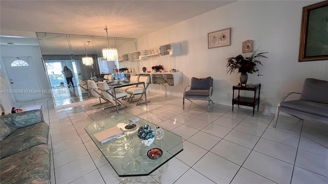 610 NE 12th Ave Unit 102, Hallandale Beach, FL 33009 - living room with a chandelier and light tile patterned floors