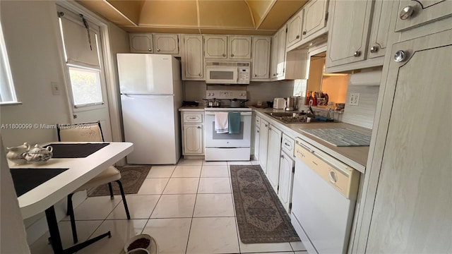 610 NE 12th Ave Unit 102, Hallandale Beach, FL 33009 - kitchen with white appliances, light countertops, and light tile patterned floors