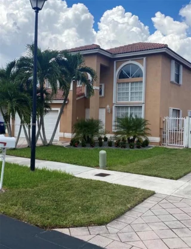16461 SW 100th Ter, Miami, FL 33196 - view of front of house with stucco siding, a tiled roof, and an attached garage