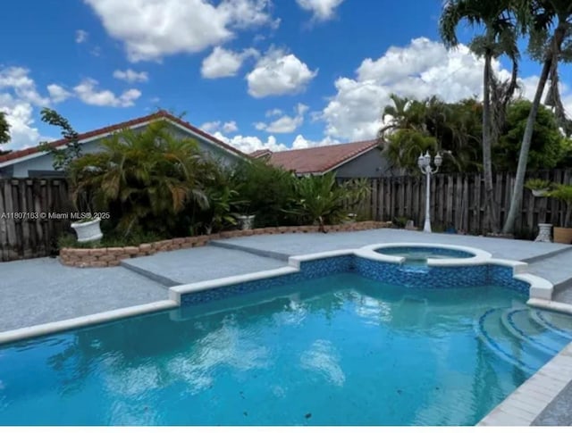 16461 SW 100th Ter, Miami, FL 33196 - view of swimming pool with a pool with connected hot tub and a patio