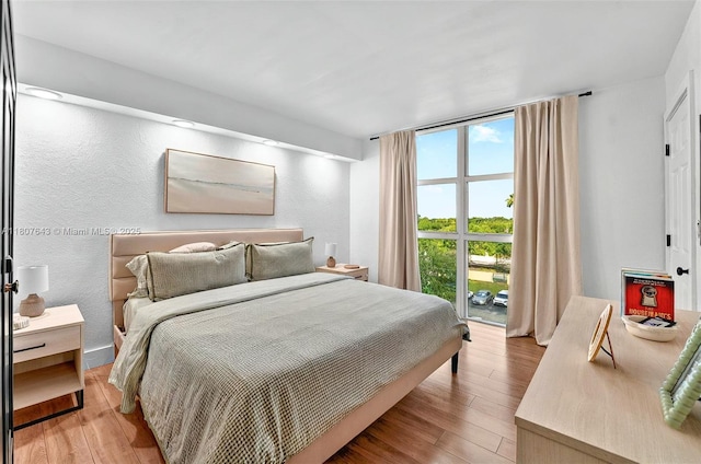2055 SW 122nd Ave Unit 524, Miami, FL 33175 - bedroom with light wood-type flooring and a textured wall