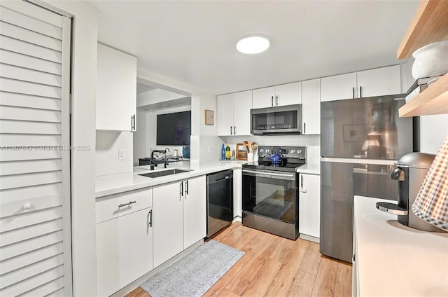 2055 SW 122nd Ave Unit 524, Miami, FL 33175 - kitchen featuring stainless steel appliances, a sink, light countertops, light wood finished floors, and white cabinetry
