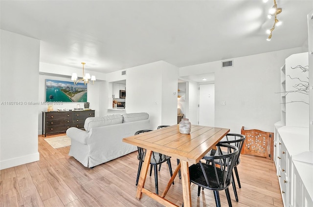 2055 SW 122nd Ave Unit 524, Miami, FL 33175 - dining area with a chandelier, light wood-style floors, and baseboards