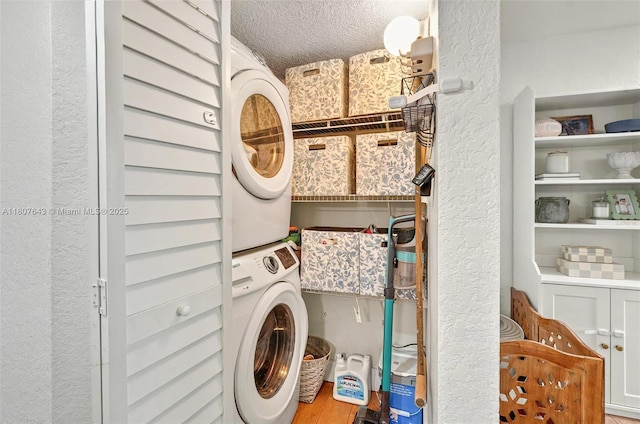 2055 SW 122nd Ave Unit 524, Miami, FL 33175 - washroom featuring stacked washer / drying machine, a textured wall, and a textured ceiling