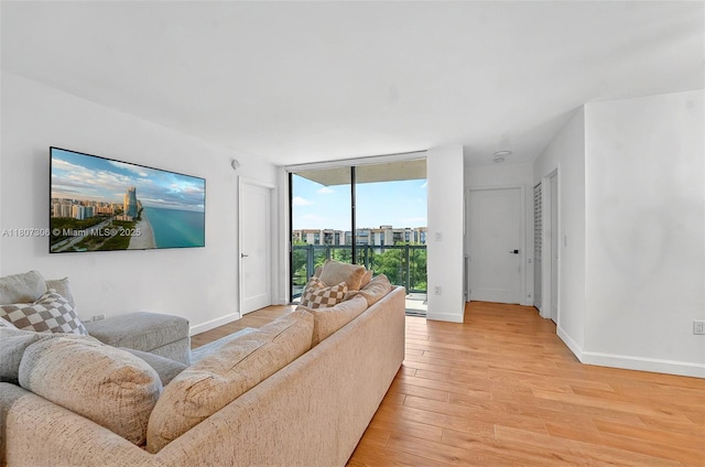 2075 SW 122nd Ave Unit 517, Miami, FL 33175 - living room with light wood finished floors, baseboards, and floor to ceiling windows