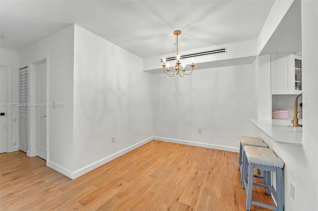 2075 SW 122nd Ave Unit 517, Miami, FL 33175 - unfurnished dining area with light wood finished floors, a chandelier, and baseboards