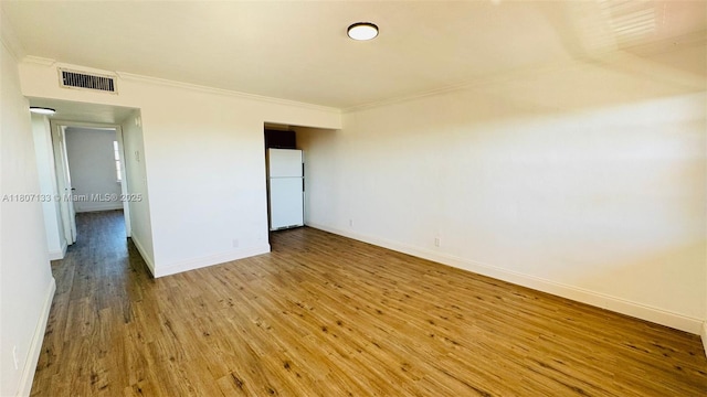 11195 SW 1st St Unit 319, Sweetwater, FL 33174 - unfurnished bedroom featuring freestanding refrigerator, ornamental molding, baseboards, and wood finished floors