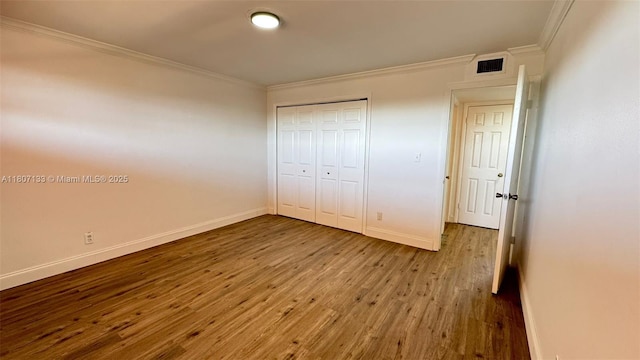 11195 SW 1st St Unit 319, Sweetwater, FL 33174 - unfurnished bedroom featuring crown molding, wood finished floors, baseboards, and a closet
