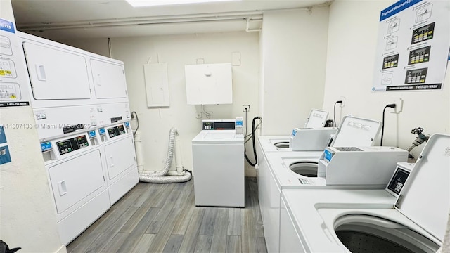11195 SW 1st St Unit 319, Sweetwater, FL 33174 - shared laundry with stacked washer and clothes dryer, light wood finished floors, washer and dryer, and electric panel
