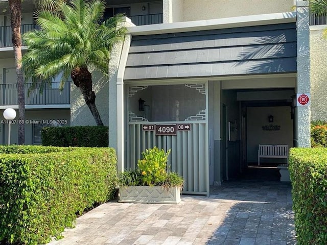 4090 Tivoli Ct Unit 201, Lake Worth, FL 33467 - view of exterior entry featuring stucco siding