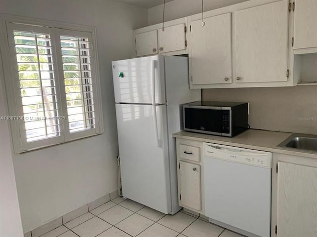 4090 Tivoli Ct Unit 201, Lake Worth, FL 33467 - kitchen with white appliances, light countertops, light tile patterned flooring, white cabinetry, and a sink
