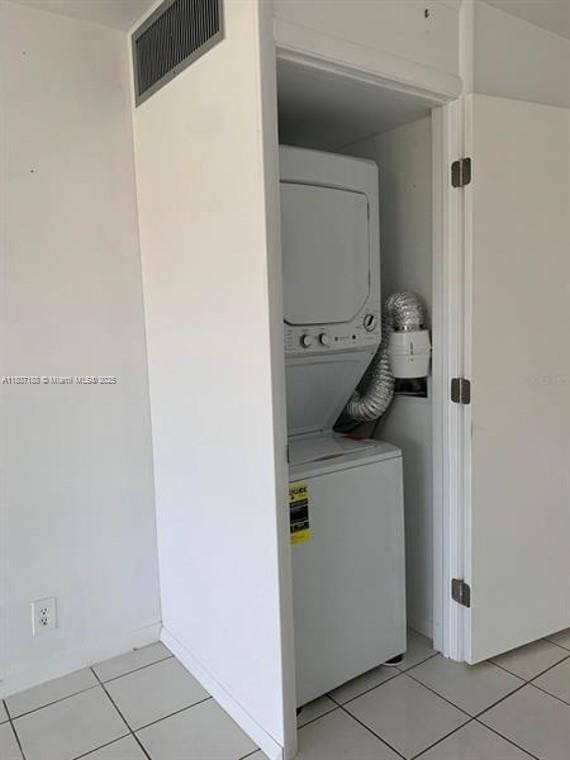 4090 Tivoli Ct Unit 201, Lake Worth, FL 33467 - laundry area with stacked washing machine and dryer and light tile patterned floors