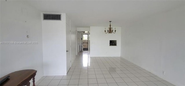 4090 Tivoli Ct Unit 201, Lake Worth, FL 33467 - unfurnished room featuring a chandelier and light tile patterned flooring