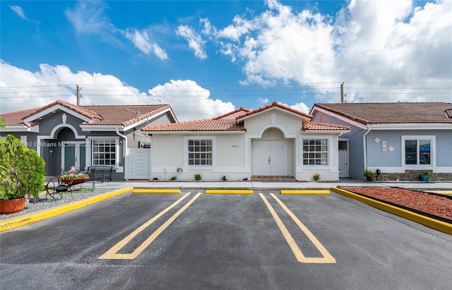 9021 NW 121st Ter Unit 85, Hialeah Gardens, FL 33018 - view of building exterior featuring uncovered parking
