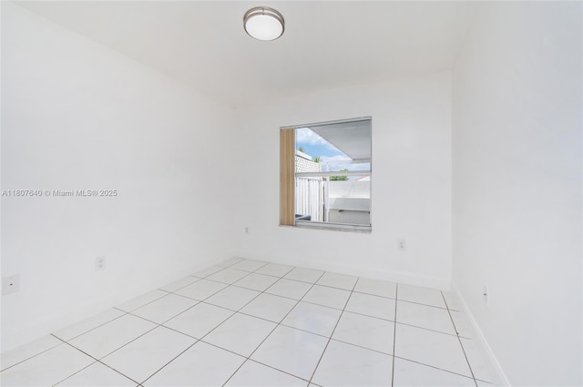 9021 NW 121st Ter Unit 85, Hialeah Gardens, FL 33018 - empty room with light tile patterned floors and baseboards