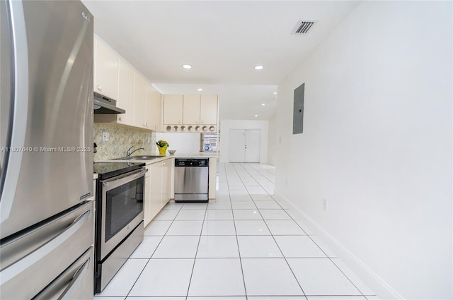 9021 NW 121st Ter Unit 85, Hialeah Gardens, FL 33018 - kitchen with stainless steel appliances, decorative backsplash, a sink, recessed lighting, and light tile patterned floors