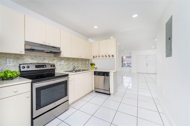 9021 NW 121st Ter Unit 85, Hialeah Gardens, FL 33018 - kitchen with under cabinet range hood, appliances with stainless steel finishes, a sink, light countertops, and recessed lighting