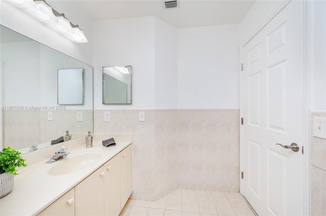 9021 NW 121st Ter Unit 85, Hialeah Gardens, FL 33018 - bathroom with tile walls, vanity, wainscoting, and tile patterned flooring