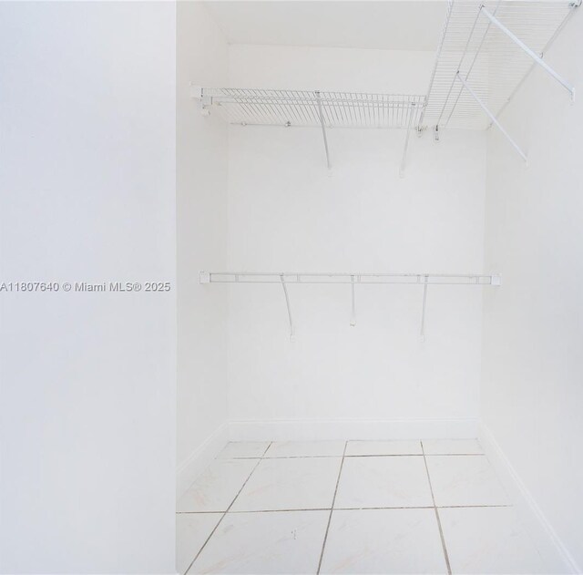 9021 NW 121st Ter Unit 85, Hialeah Gardens, FL 33018 - walk in closet with light tile patterned floors