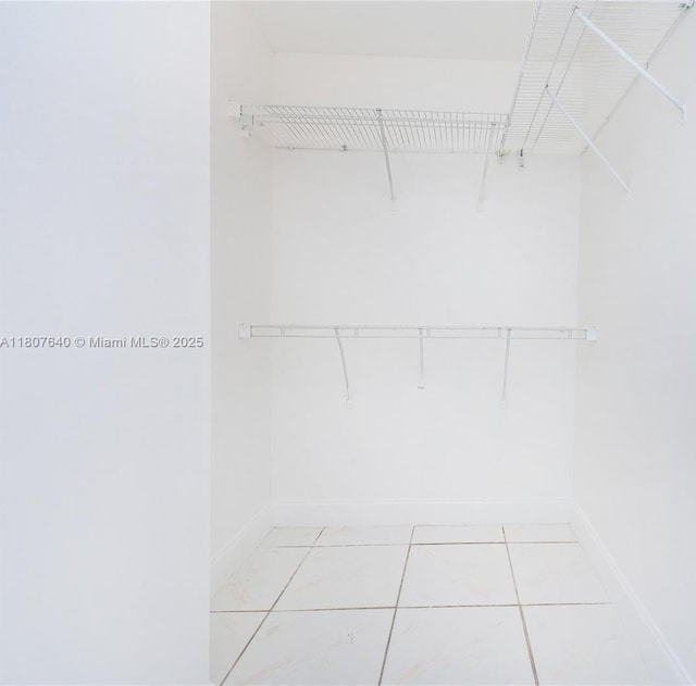 9021 NW 121st Ter Unit 85, Hialeah Gardens, FL 33018 - walk in closet with light tile patterned floors