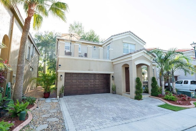 4832 SW 159th Ave, Miramar, FL 33027 - view of front of house featuring a balcony, stucco siding, decorative driveway, a garage, and a tiled roof