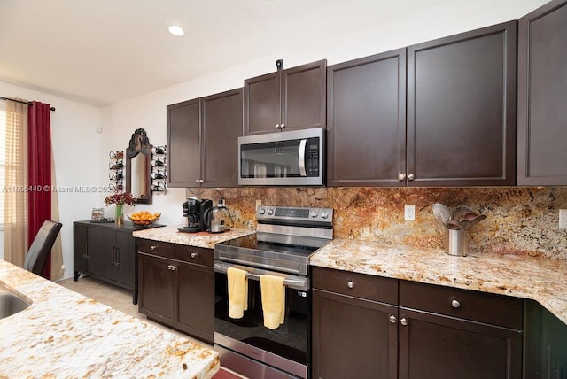 4832 SW 159th Ave, Miramar, FL 33027 - kitchen with stainless steel appliances, decorative backsplash, dark brown cabinets, light stone countertops, and recessed lighting