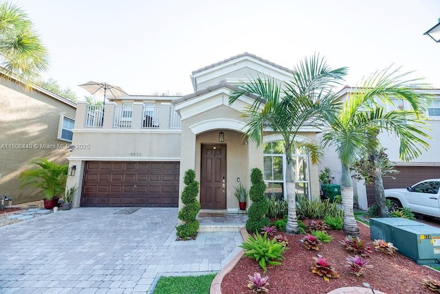 4832 SW 159th Ave, Miramar, FL 33027 - view of front of house with a balcony, stucco siding, decorative driveway, and a garage