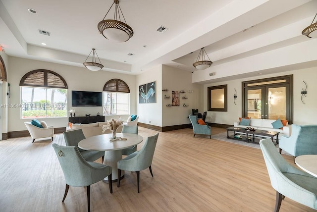 4832 SW 159th Ave, Miramar, FL 33027 - dining room featuring a tray ceiling, light wood-type flooring, baseboards, and french doors