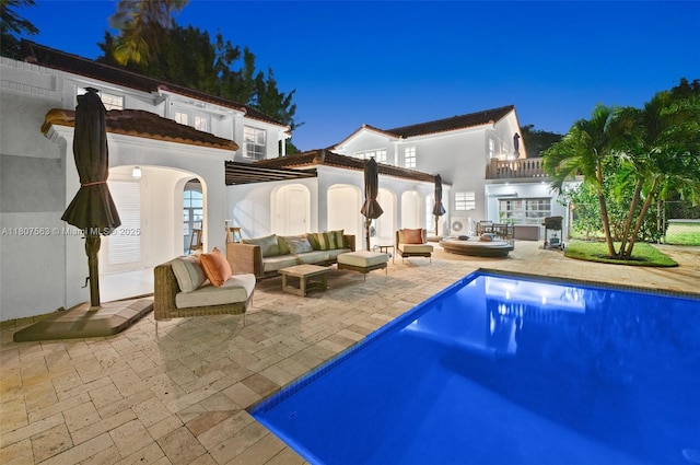 321 SW 1st Ave, Boynton Beach, FL 33435 - pool at twilight featuring outdoor lounge area, a patio area, and an outdoor pool