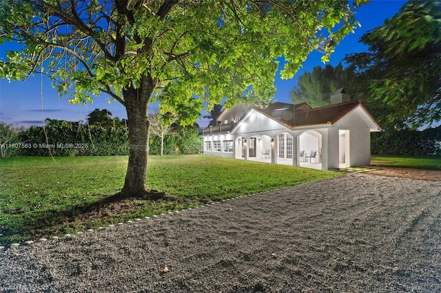 321 SW 1st Ave, Boynton Beach, FL 33435 - view of front facade featuring a front lawn, stucco siding, and a chimney