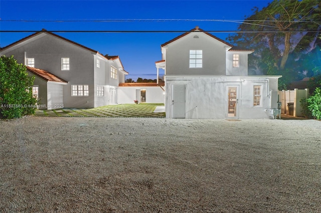 321 SW 1st Ave, Boynton Beach, FL 33435 - back of property with stucco siding and a patio area