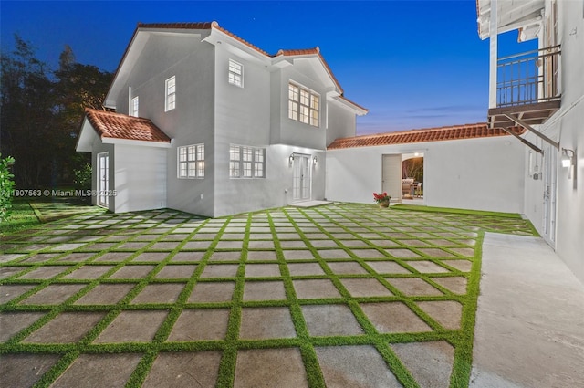 321 SW 1st Ave, Boynton Beach, FL 33435 - rear view of house with a tile roof, a patio area, and stucco siding